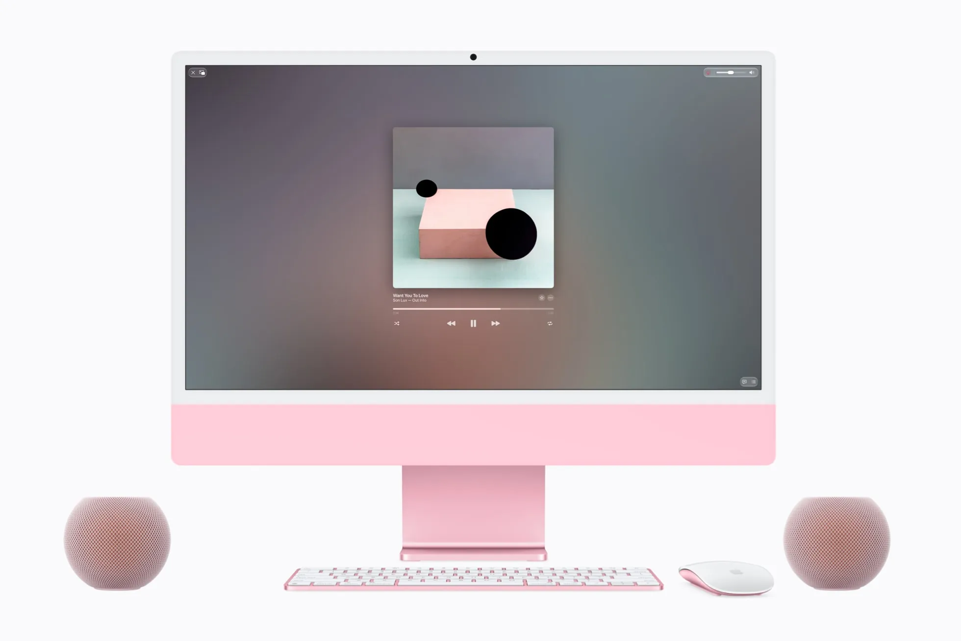 Two pink HomePod mini 2 speakers next to a pink iMac
